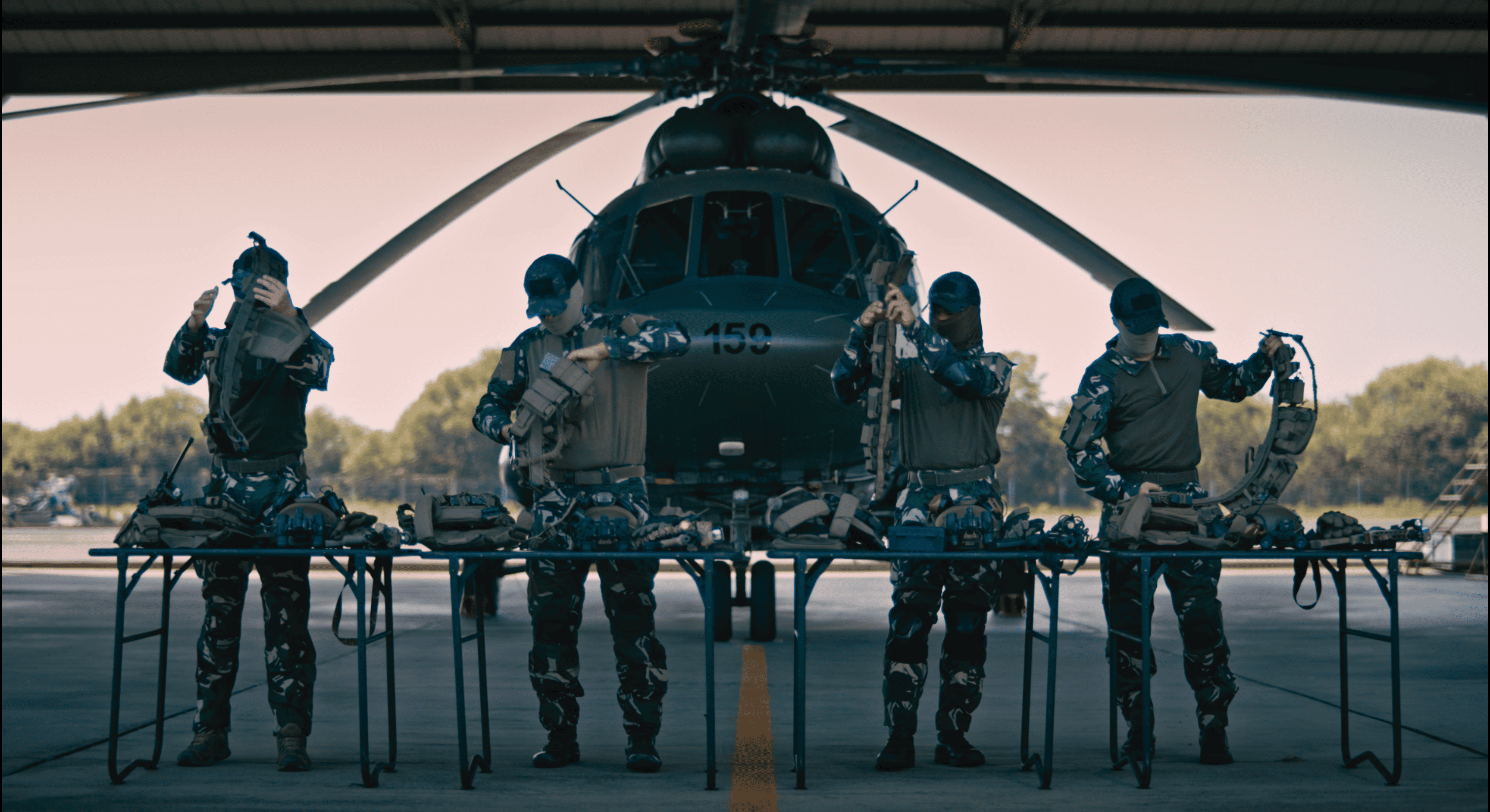 Military personnel with helicopter